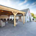 Douglas overkapping met loungeset op een terras aan het water